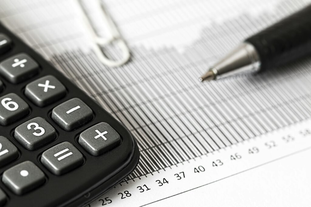 pexels photo 209224 209224 Close-up of a calculator and pen on a bar graph, representing finance and accounting.